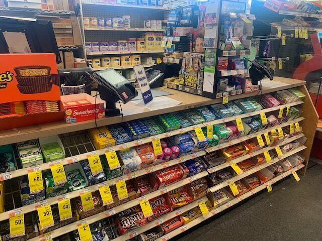 Countertop displays positioned in the checkout area presenting impulse products while maintaining comfortable cashier workflow.